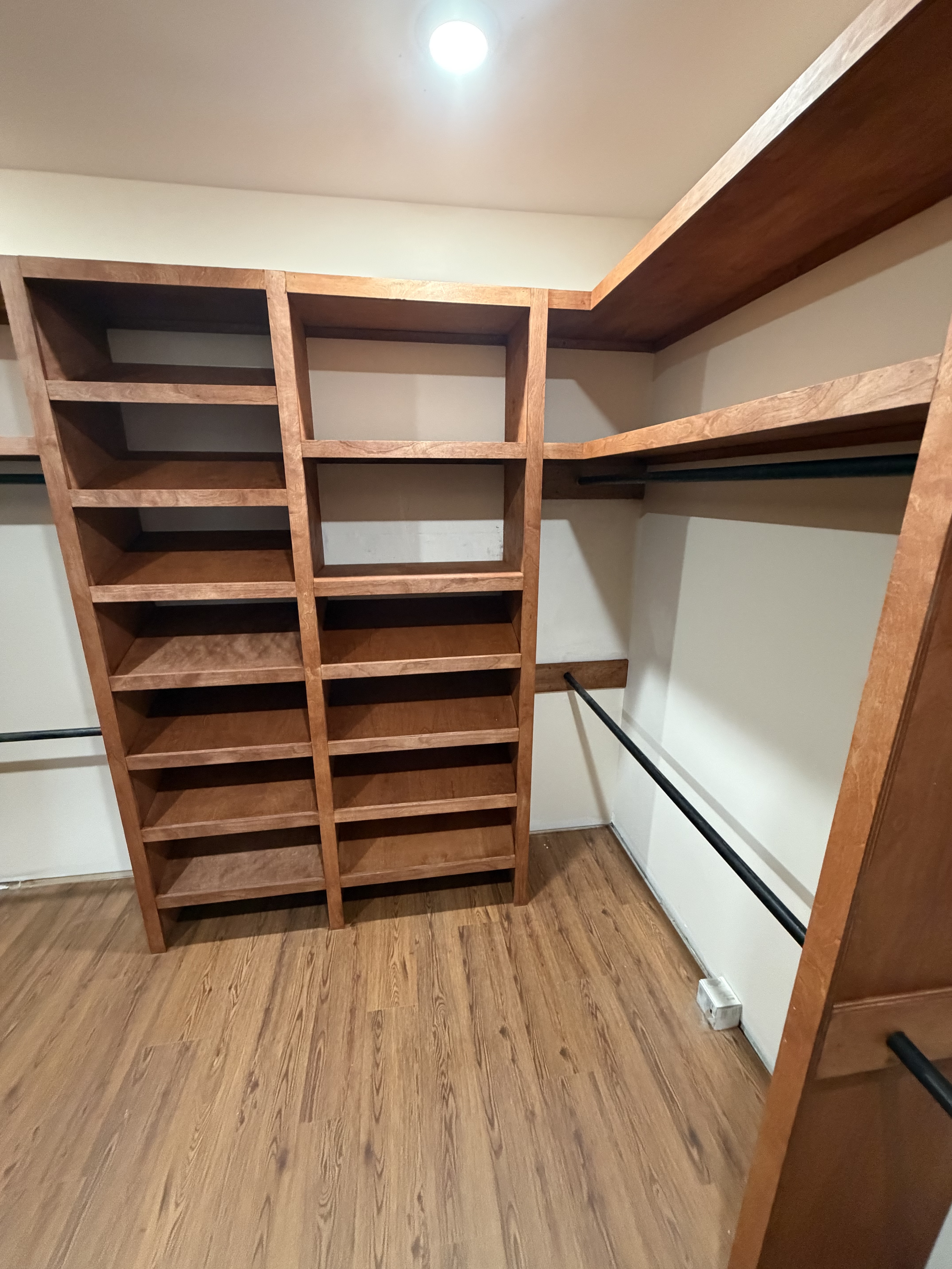 Custom walk-in closet with built-in wood shelving