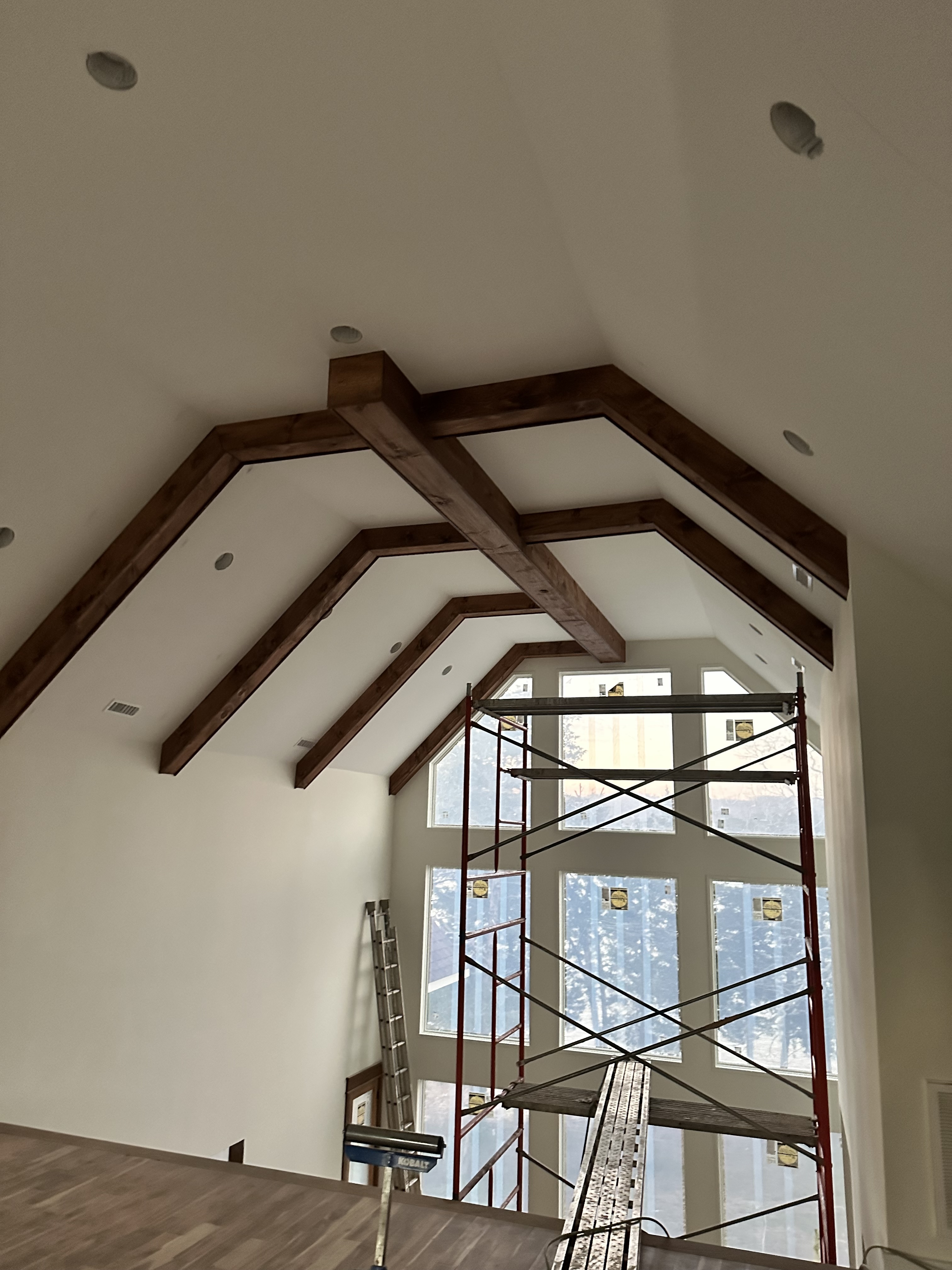 Custom wooden ceiling beams on vaulted great room ceiling