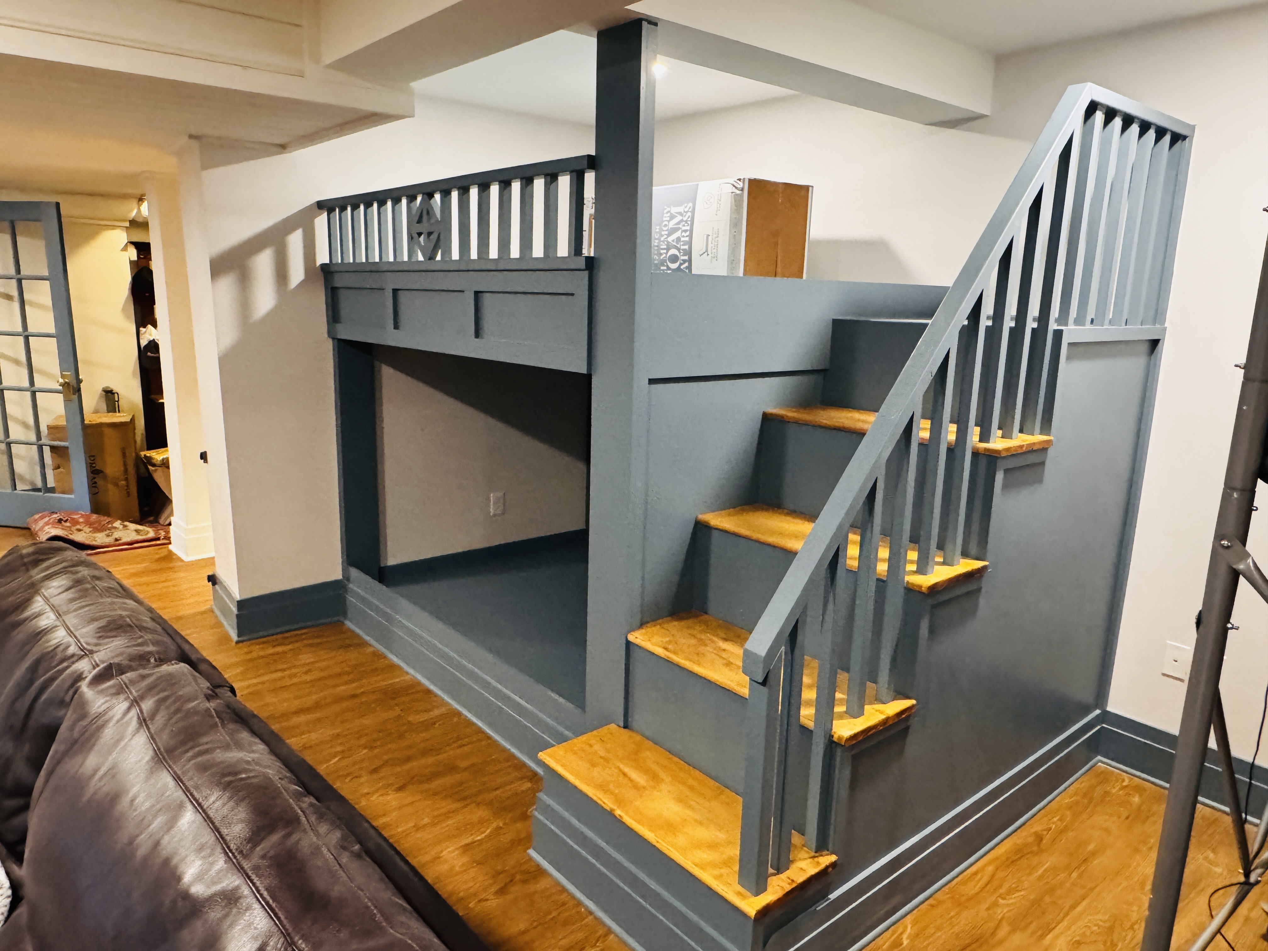 Custom built-in bunk bed with wooden staircase